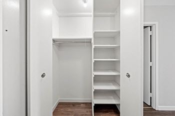 A white closet with shelves and drawers.